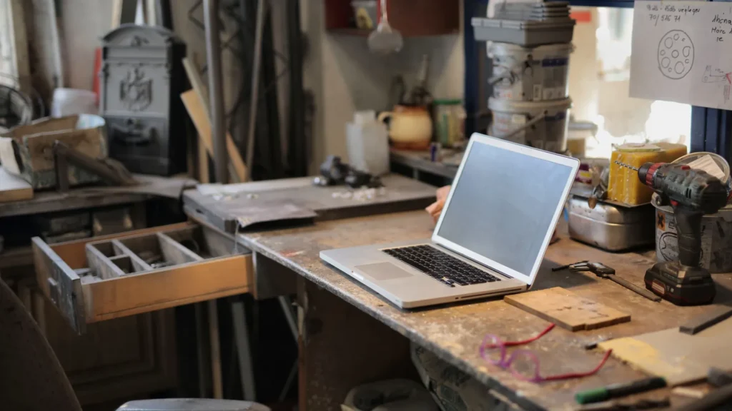 Laptop and tools on a workshop bench